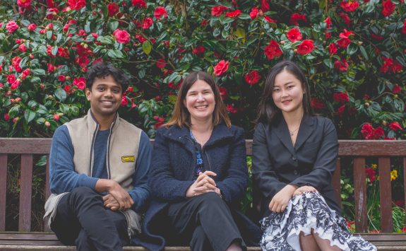 Ruth Valentine sat on a bench on campus with Lulu Chen, Education Officer, and Chirag Kumar, Postgraduate Officer.